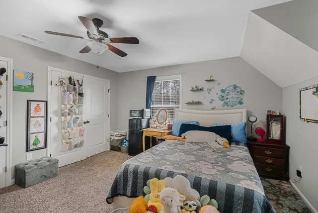 a bedroom with a bed and dresser