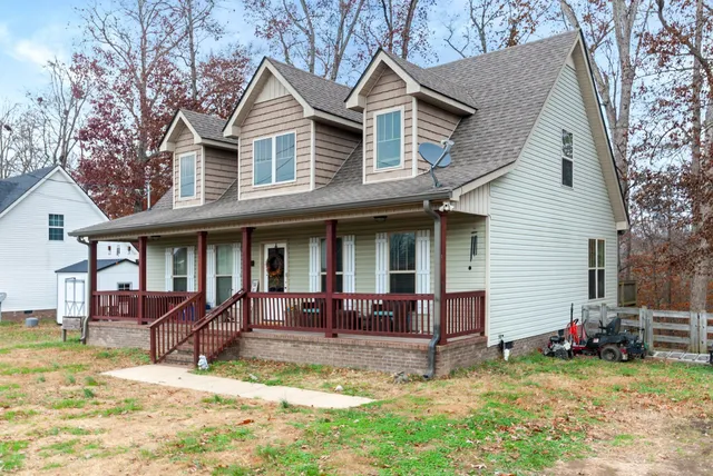 a view of a house with a yard and sitting area