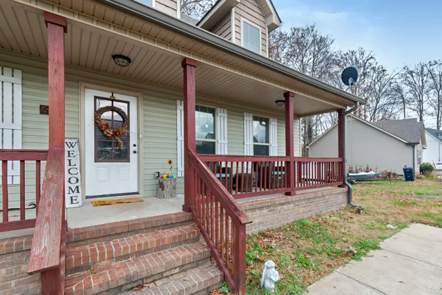a view of a house with large windows and wooden fence