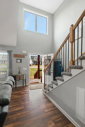 a view of entryway and hall with wooden floor