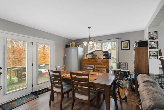 a view of a dining room with furniture window and wooden floor
