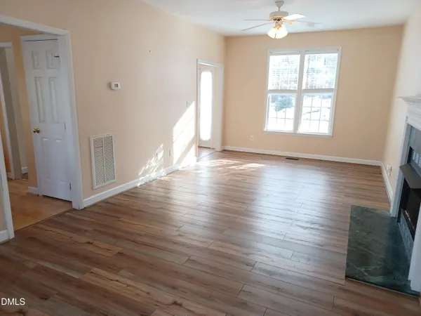 an empty room with windows and closet