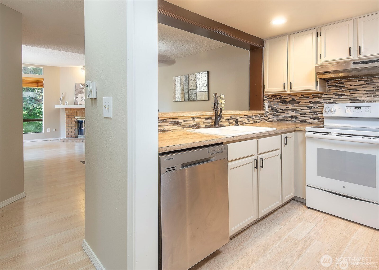 134 Southwest 116th Street, Unit H21 Seattle, WA 98146 - Photo 6 of 16 a kitchen with white cabinets and white appliances