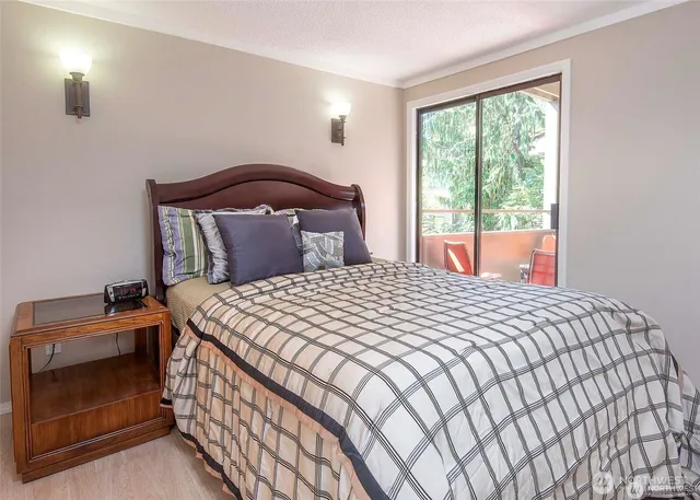 a bedroom with a bed and a lamp