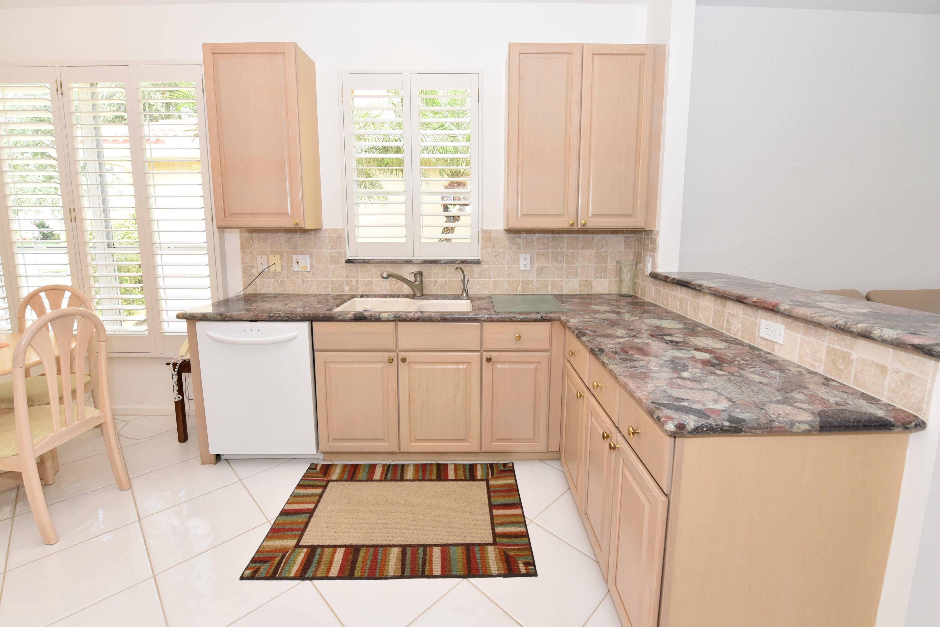 23358 Torre Circle Boca Raton, FL 33433 - Photo 14 of 34 a kitchen with a sink stove and cabinets