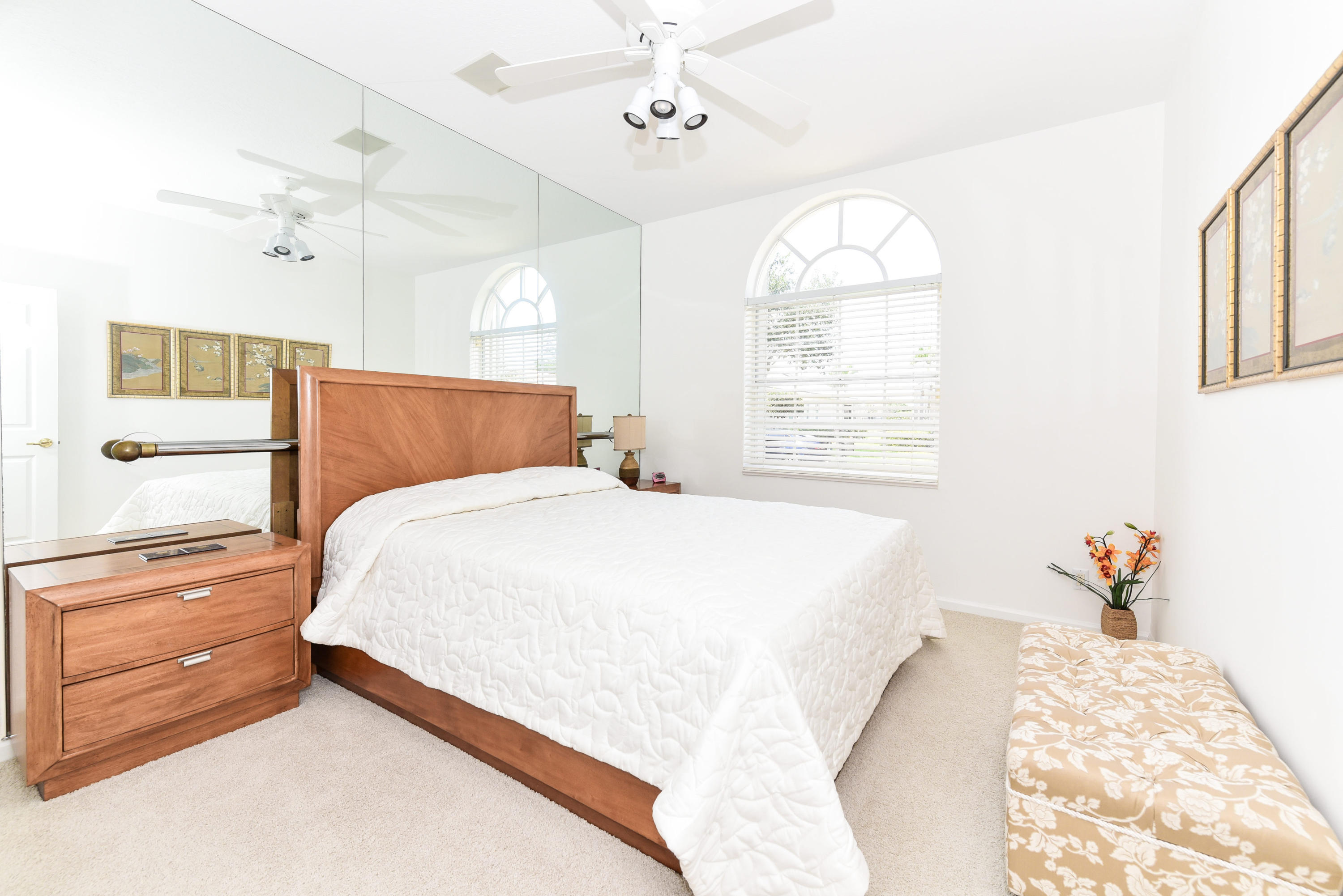 23358 Torre Circle Boca Raton, FL 33433 - Photo 18 of 34 a bedroom with a bed and a chandelier