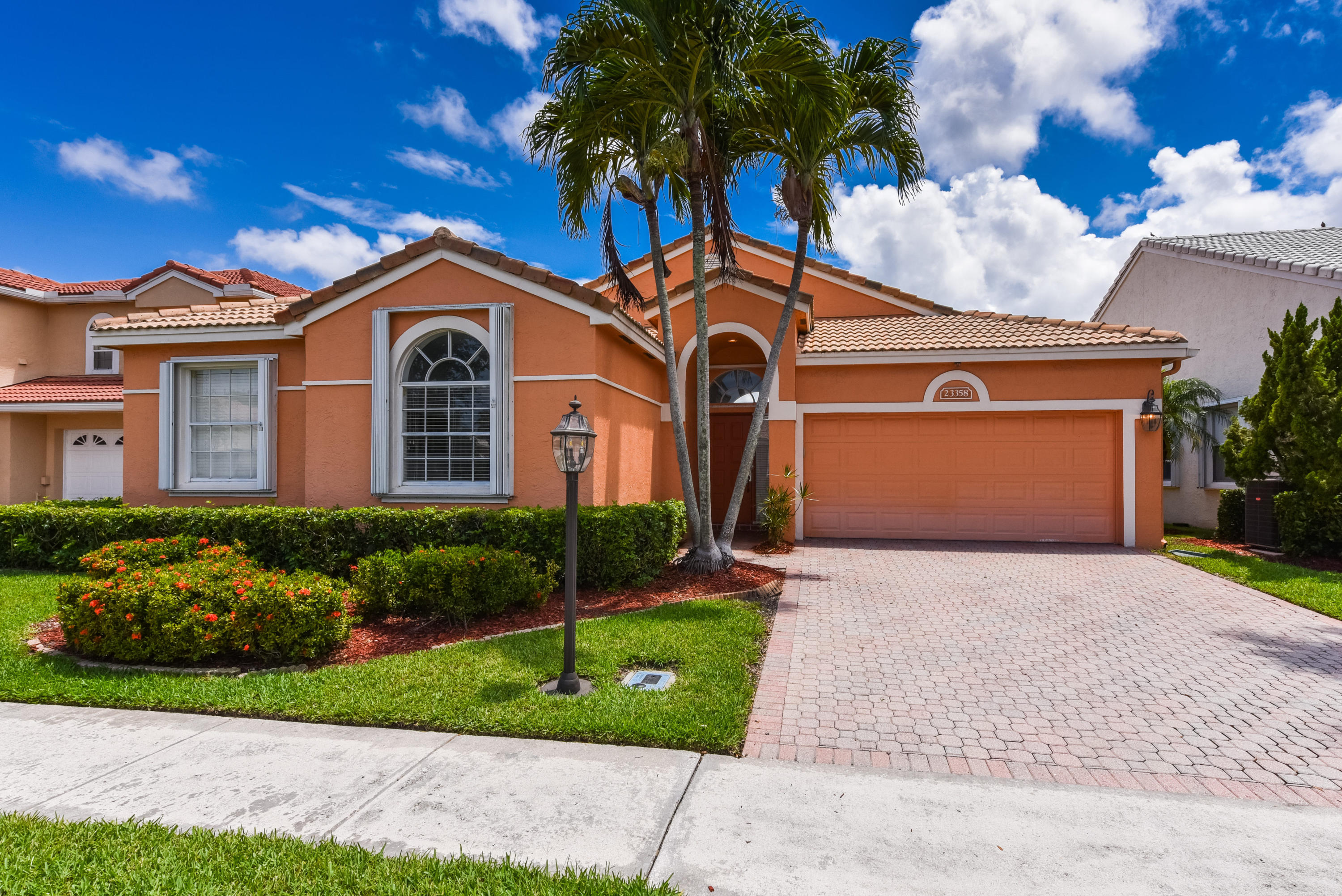 23358 Torre Circle Boca Raton, FL 33433 - Photo 2 of 34 a front view of a house with a yard and garage