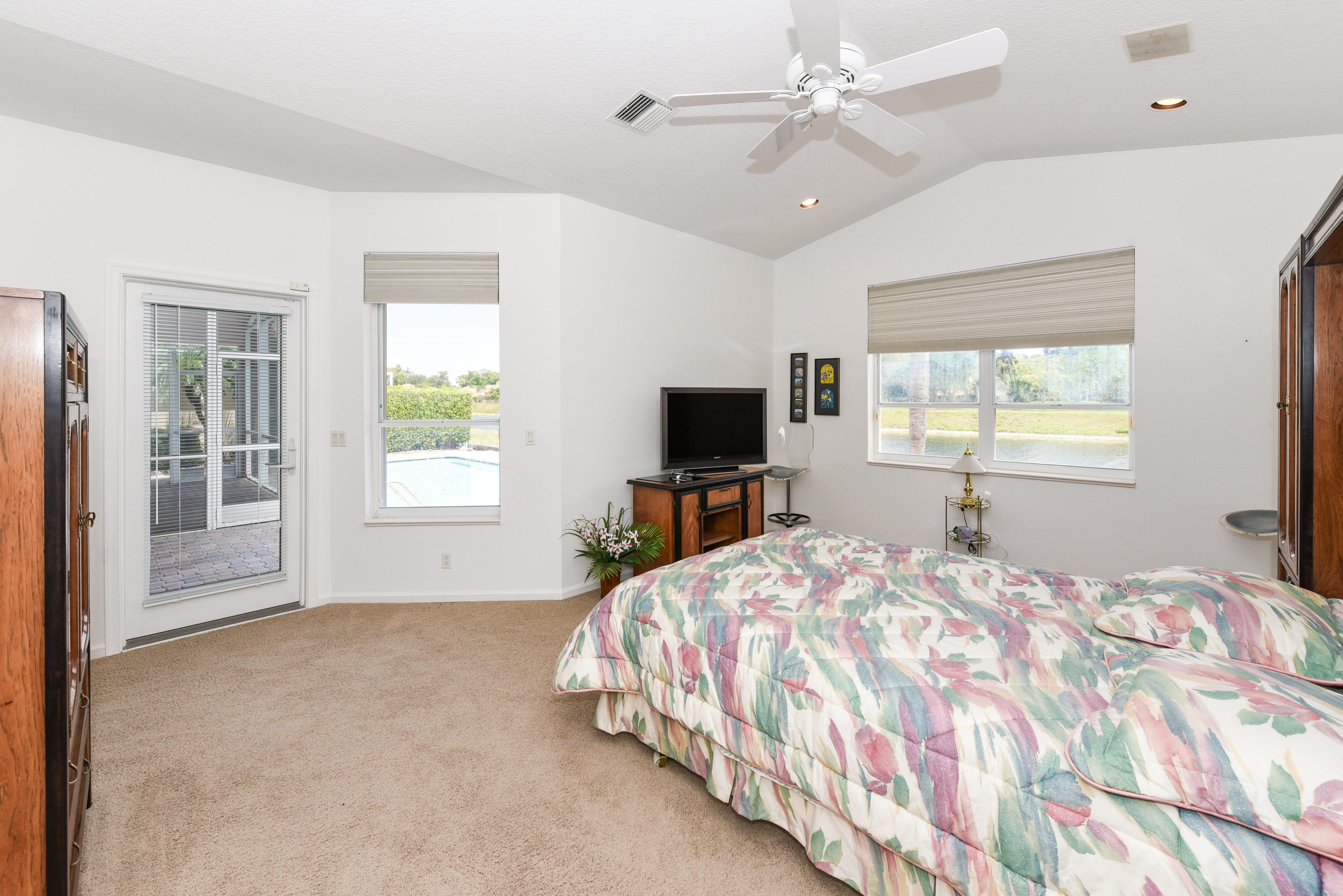 23358 Torre Circle Boca Raton, FL 33433 - Photo 21 of 34 a bedroom with a large bed and a window