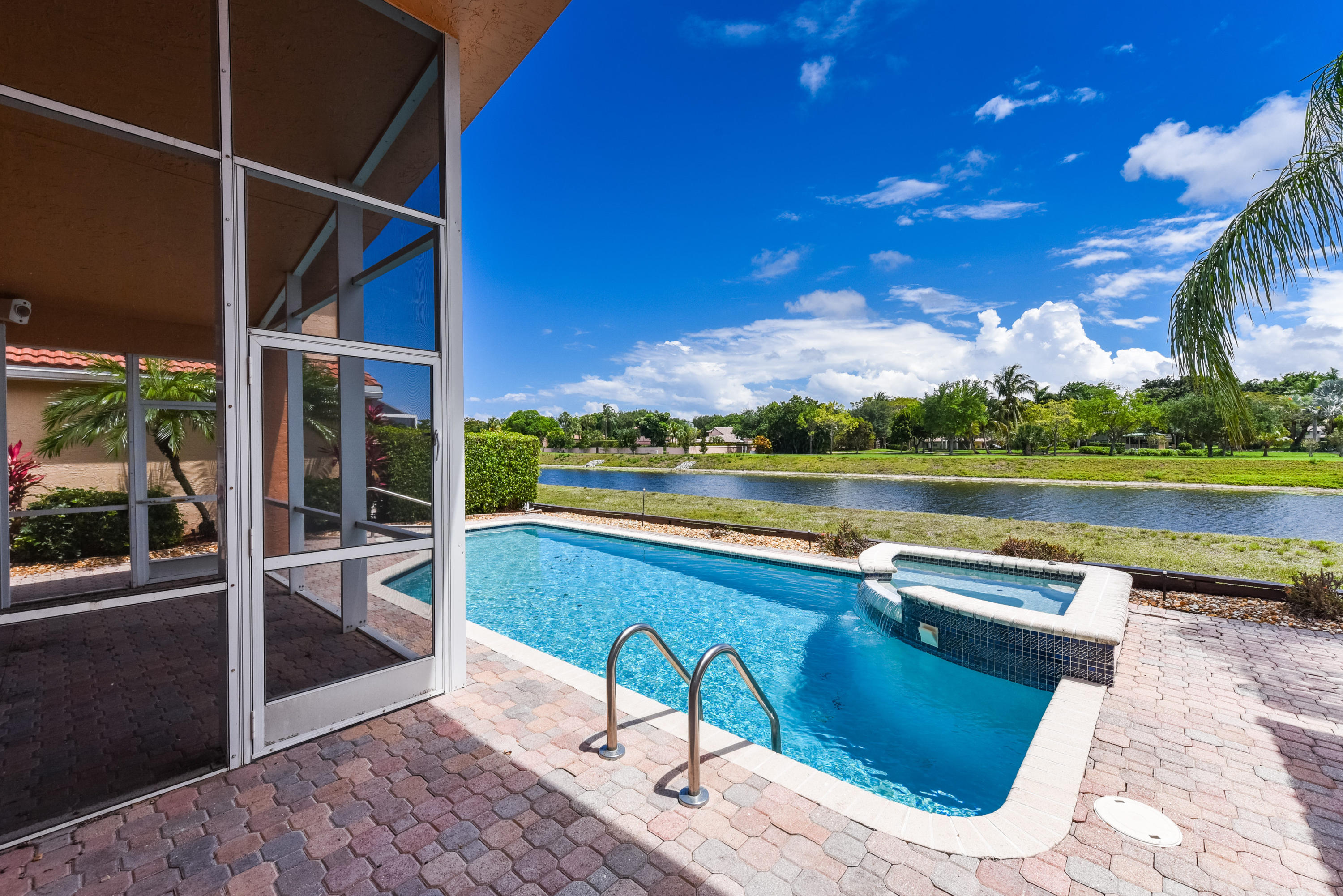 23358 Torre Circle Boca Raton, FL 33433 - Photo 25 of 34 a view of swimming pool with outdoor seating and lake