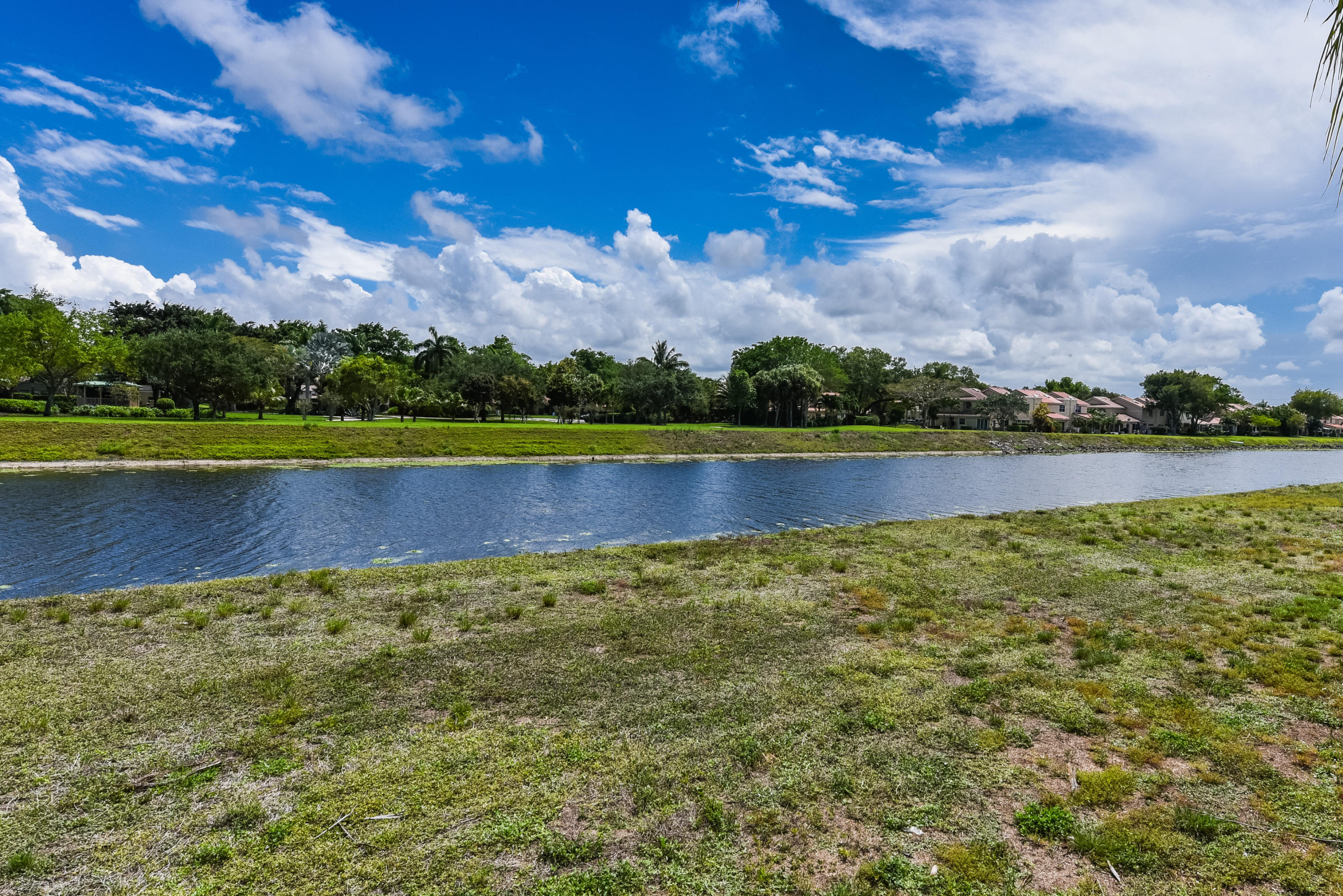 23358 Torre Circle Boca Raton, FL 33433 - Photo 28 of 34 a view of a lake with houses in the background