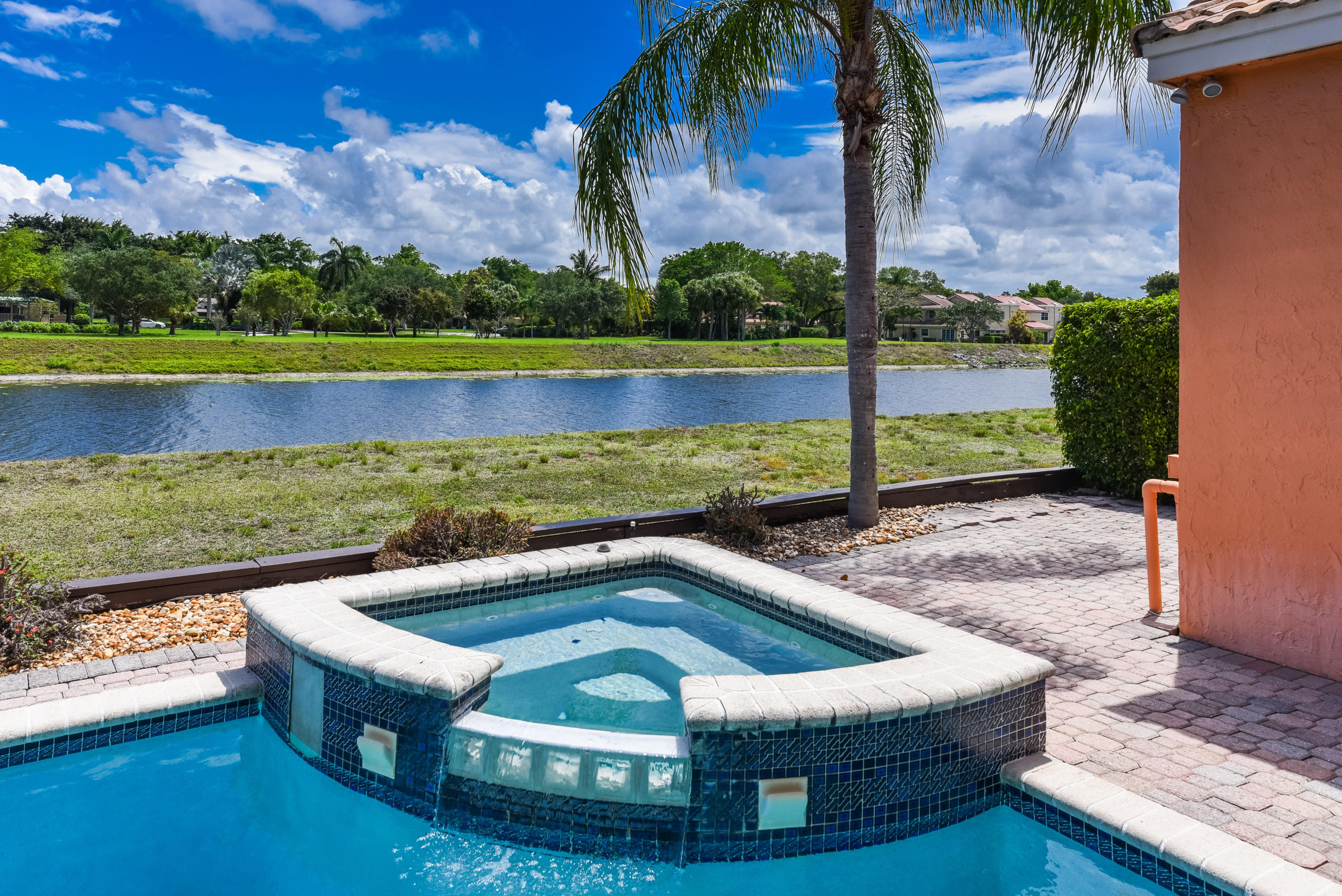 23358 Torre Circle Boca Raton, FL 33433 - Photo 30 of 34 a view of a swimming pool with a lounge chairs