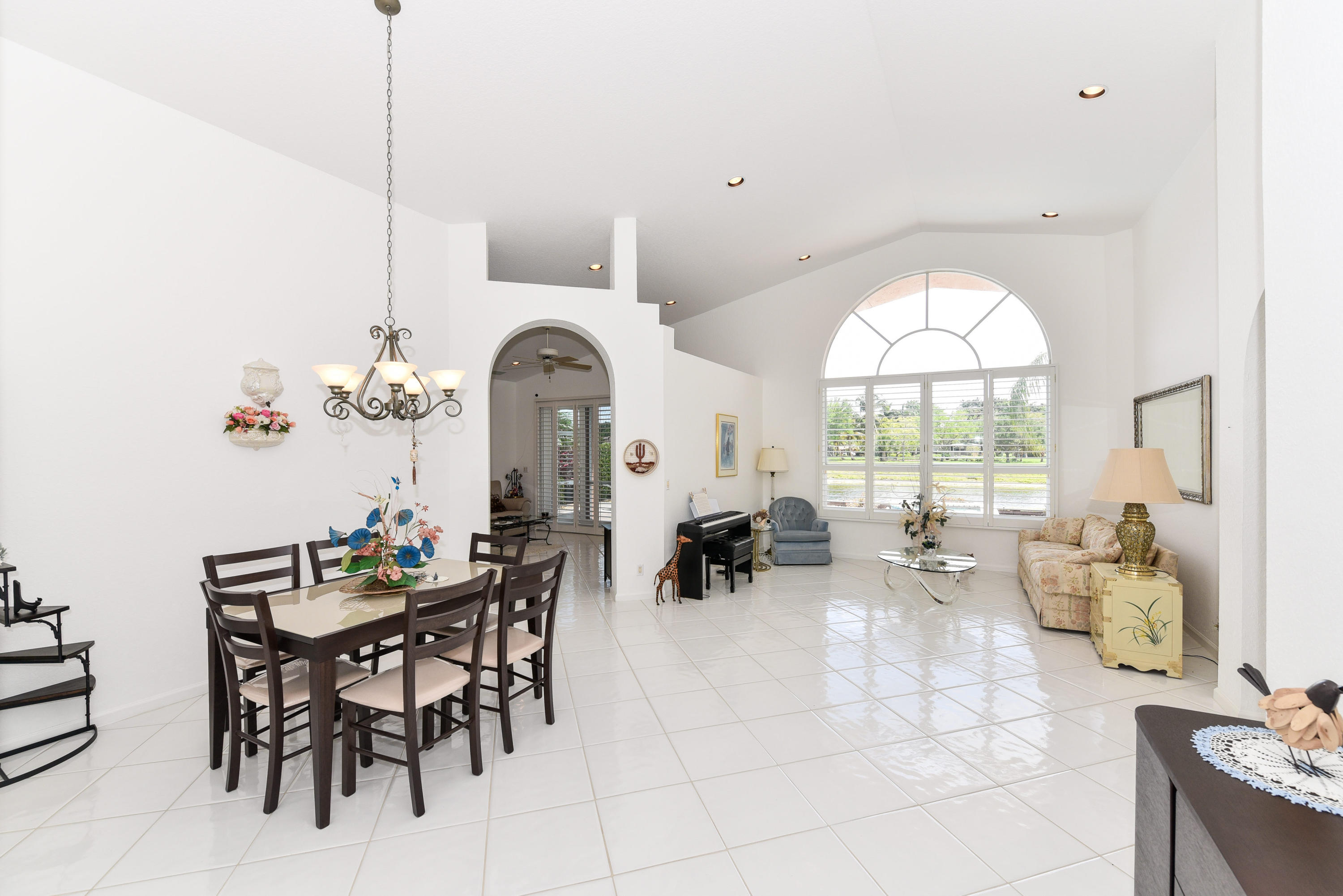 23358 Torre Circle Boca Raton, FL 33433 - Photo 4 of 34 a group of people sitting in a living room with a large window