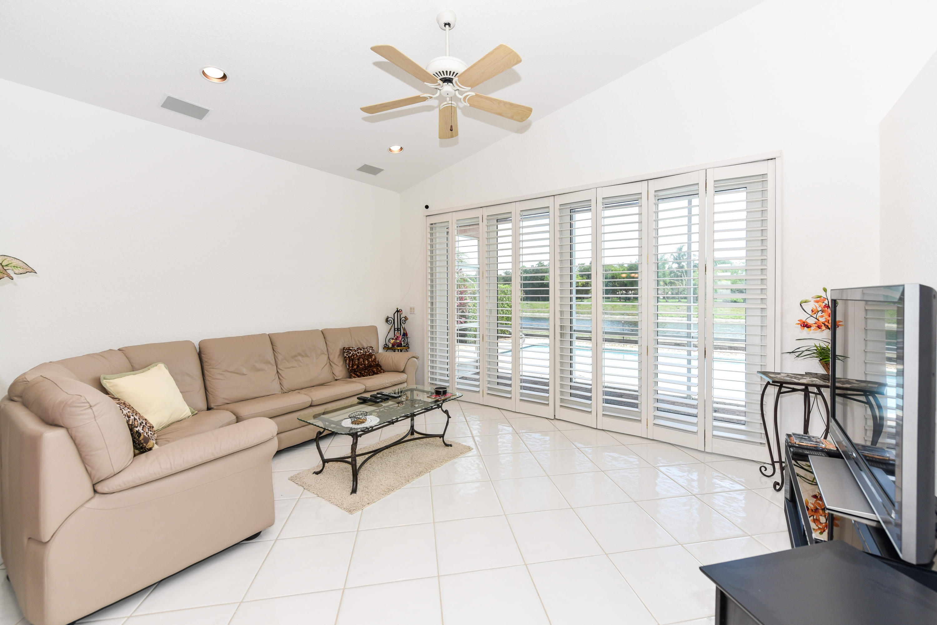 23358 Torre Circle Boca Raton, FL 33433 - Photo 9 of 34 a living room with furniture and a floor to ceiling window