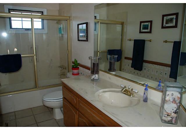 520 Amigos Road Ramona, CA 92065 - Photo 13 of 17 Guest Bath has tub & shower with glass door enclosure. Tiled floor.