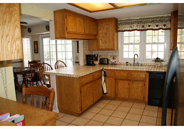520 Amigos Road Ramona, CA 92065 - Photo 3 of 17 Breakfast bar, tiled counters & floor. View of back yard & pool.
