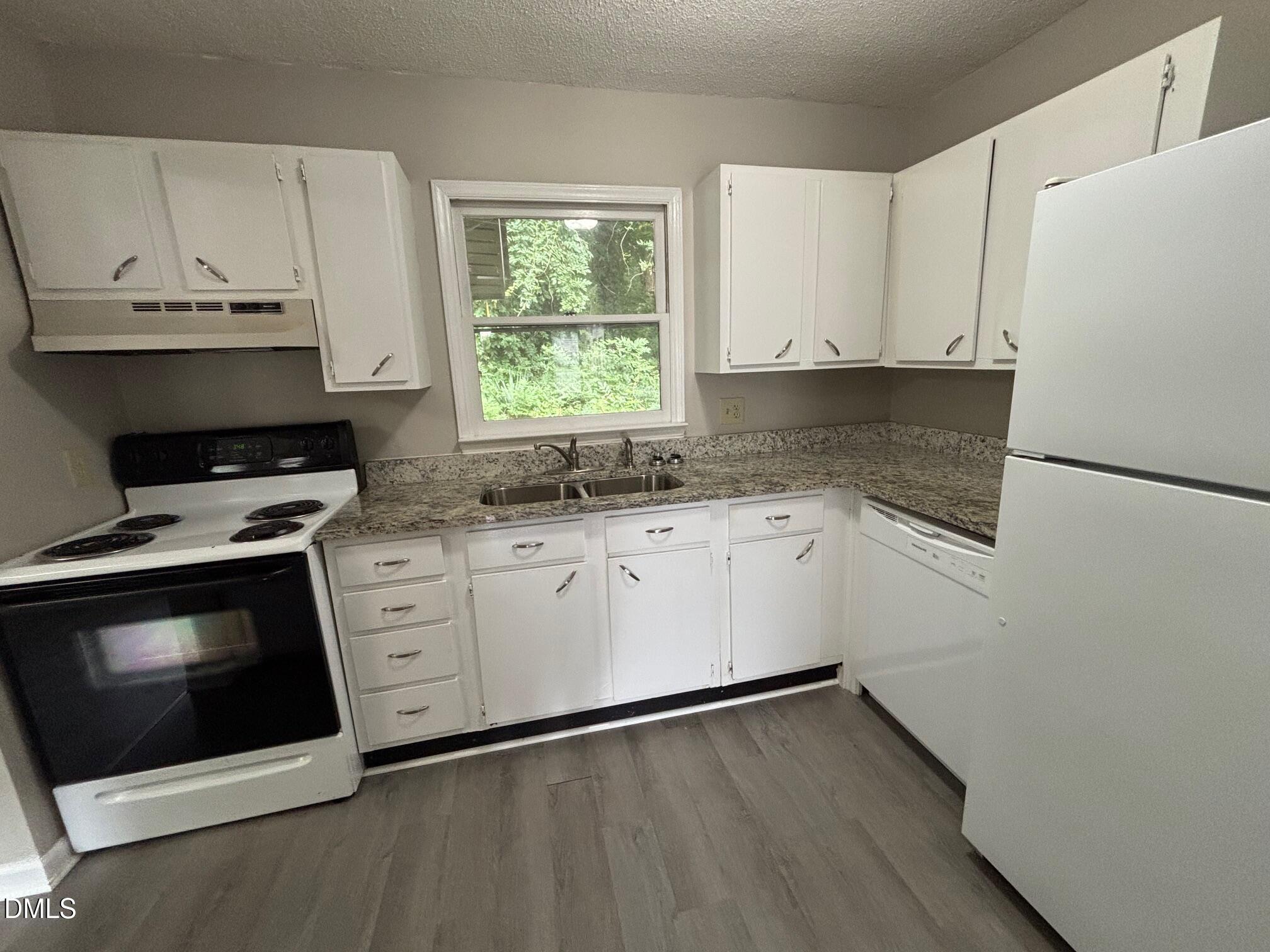 524 Boone Road Eden, NC 27288 - Photo 6 of 12 a kitchen with stainless steel appliances a stove a sink and a microwave