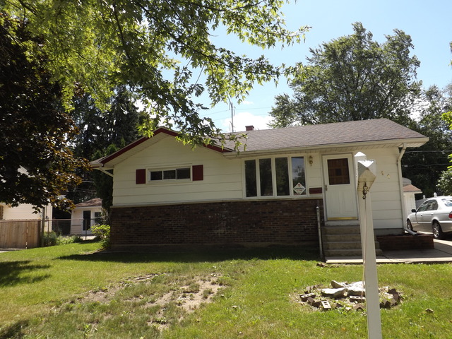 2411 West Cheyenne Road Waukegan, IL 60087 - Photo 1 of 18 a front view of a house with a yard