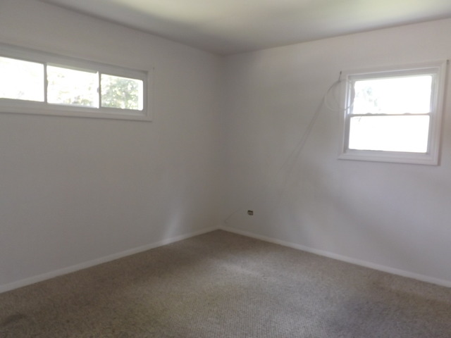 2411 West Cheyenne Road Waukegan, IL 60087 - Photo 7 of 18 an empty room with a window