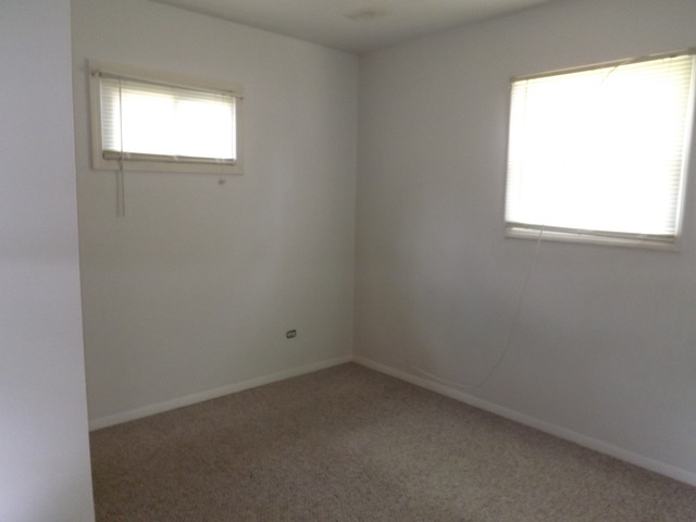 2411 West Cheyenne Road Waukegan, IL 60087 - Photo 8 of 18 an empty room with a window