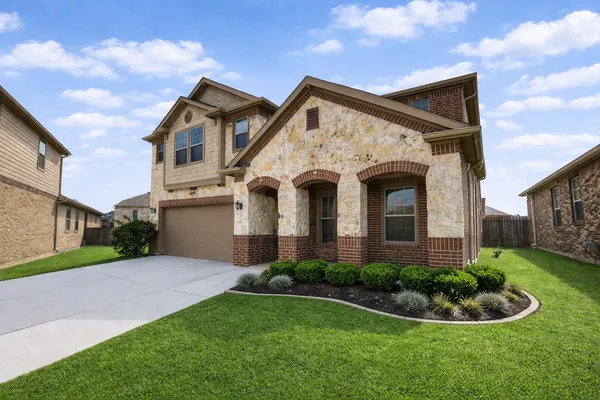 a front view of a house with a yard and garage