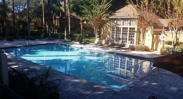 a view of swimming pool with outdoor seating and plants