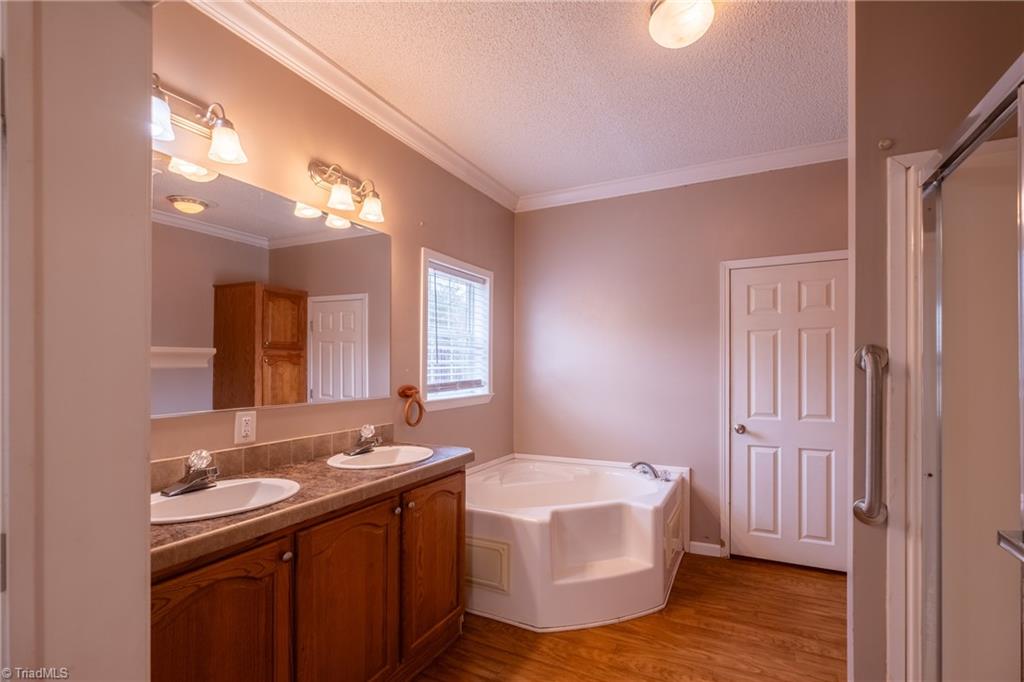 485 Amos Road Madison, NC 27025 - Photo 19 of 37 Primary bath, double vanity, garden tub and separate shower