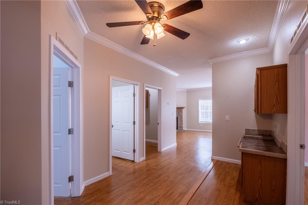 485 Amos Road Madison, NC 27025 - Photo 23 of 37 Hallway to bedrooms 2, 3 and 4, laundry room and great room
