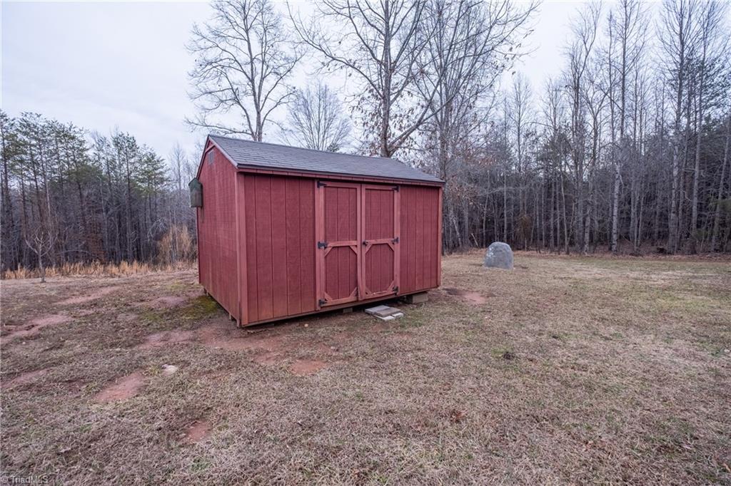 485 Amos Road Madison, NC 27025 - Photo 6 of 37 Storage shed at rear of home
