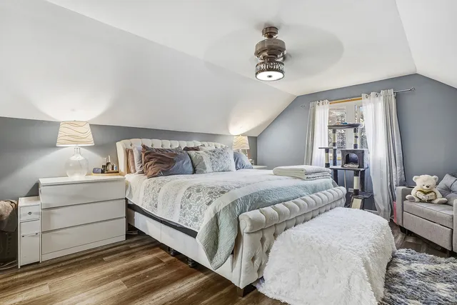 a bedroom with a large bed and a chandelier