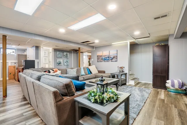 a living room with furniture and a wooden floor