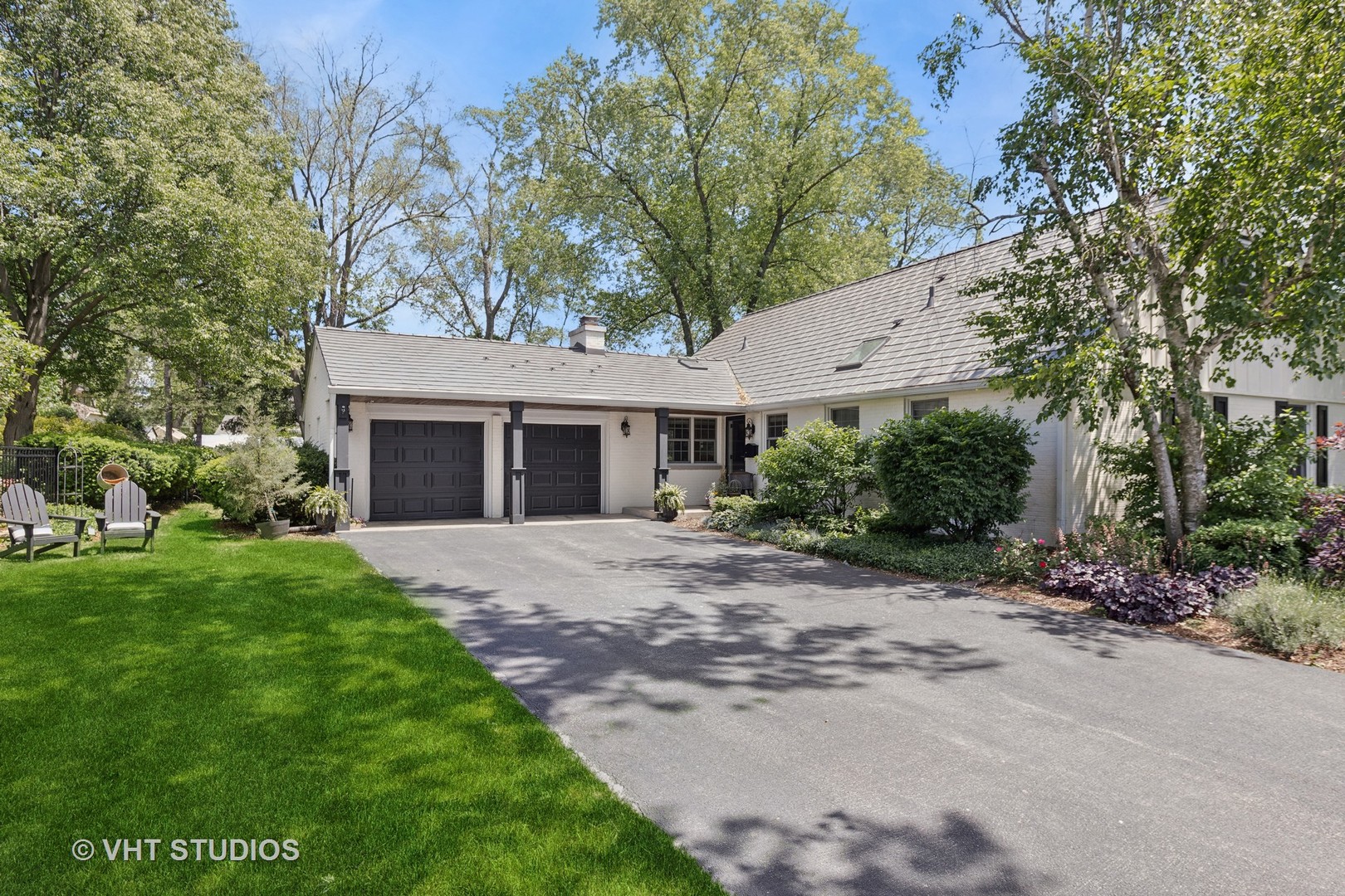 1305 Gamon Road Wheaton, IL 60189 - Photo 1 of 30 a front view of a house with a garden and trees