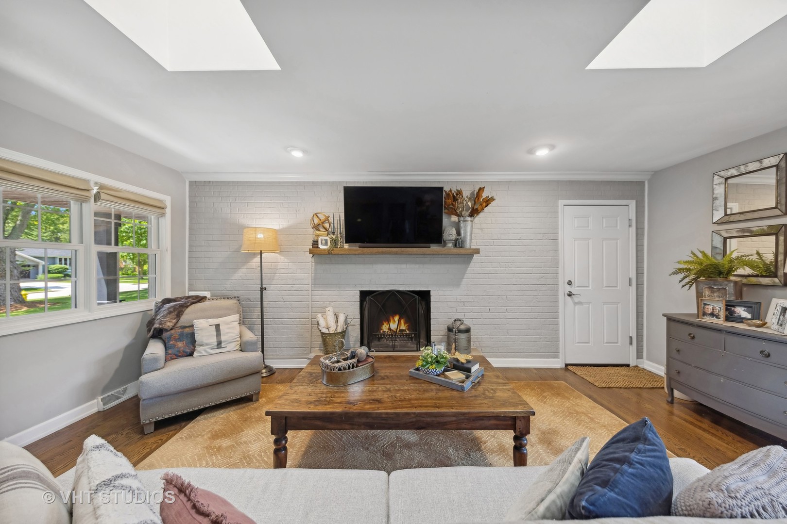 1305 Gamon Road Wheaton, IL 60189 - Photo 11 of 30 a living room with furniture a flat screen tv and a fireplace