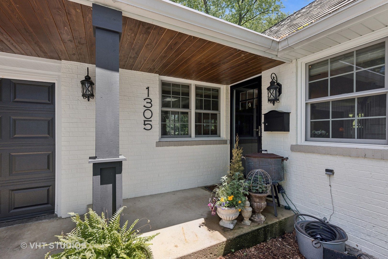 1305 Gamon Road Wheaton, IL 60189 - Photo 2 of 30 a front view of a house with a garden