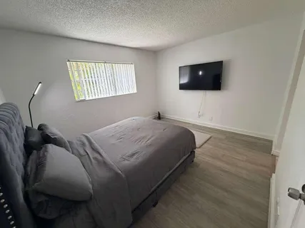 a bedroom with a bed and a flat screen tv