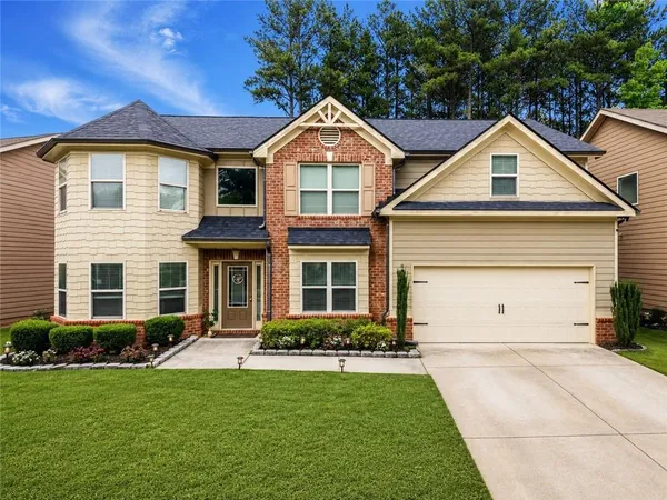 a front view of a house with a yard