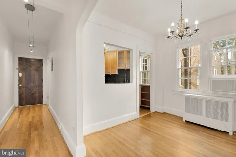 a view of a room with wooden floor and windows