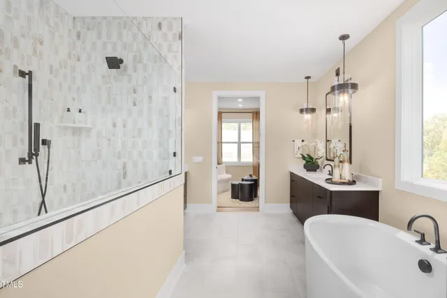 a bathroom with a tub sink and mirror