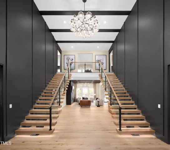 a view of entryway and hall with wooden floor