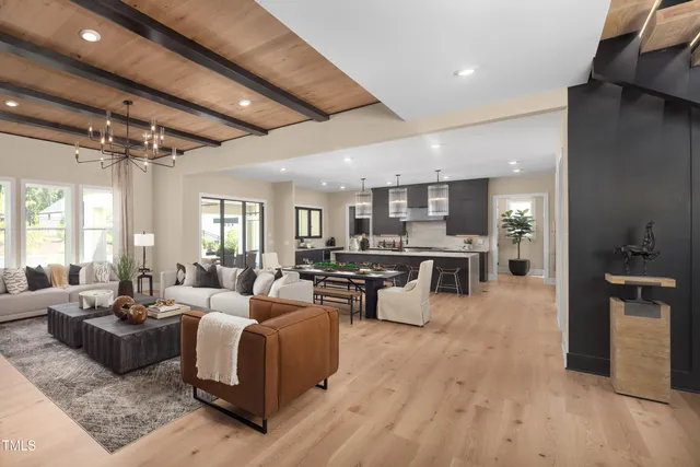a living room with lots of furniture and kitchen view