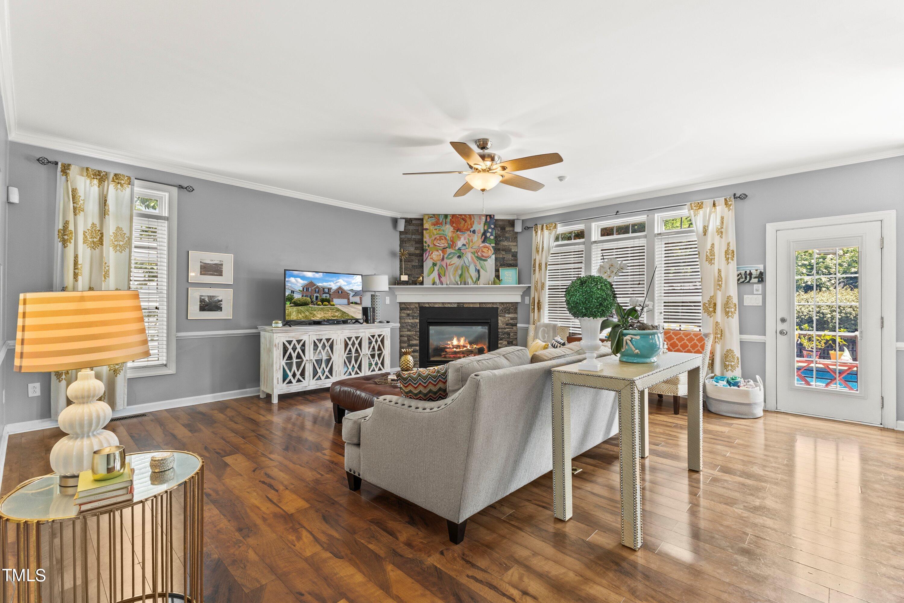 12212 Penrose Trail Raleigh, NC 27614 - Photo 11 of 41 a living room with furniture a fireplace and a large window