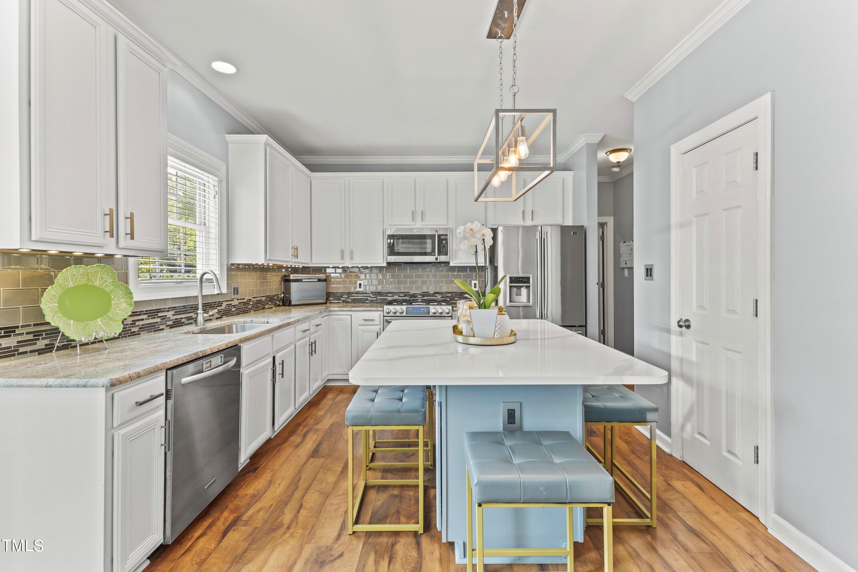 12212 Penrose Trail Raleigh, NC 27614 - Photo 15 of 41 a kitchen with kitchen island granite countertop a sink appliances cabinets and furniture