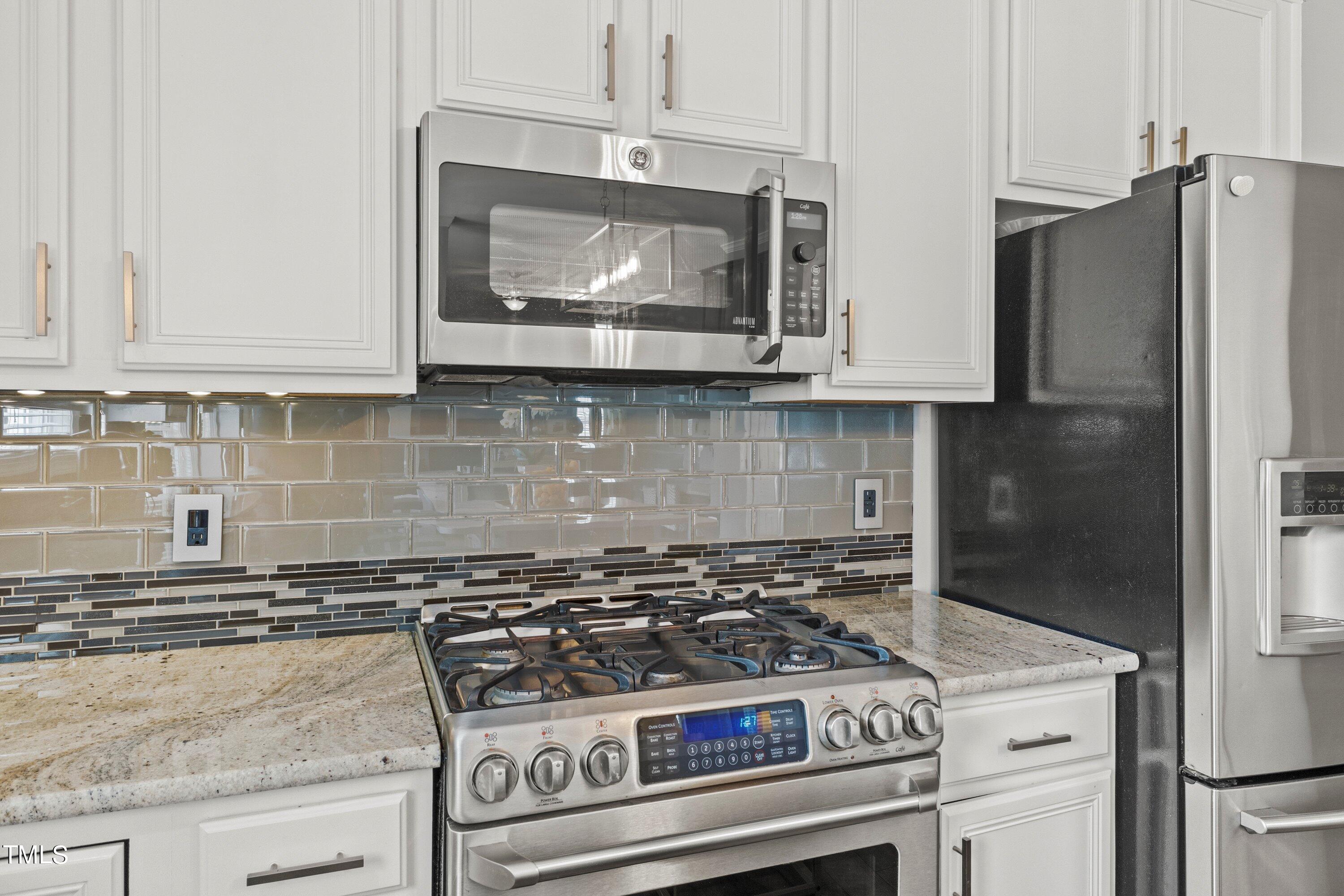 12212 Penrose Trail Raleigh, NC 27614 - Photo 19 of 41 a stove top oven sitting inside of a kitchen