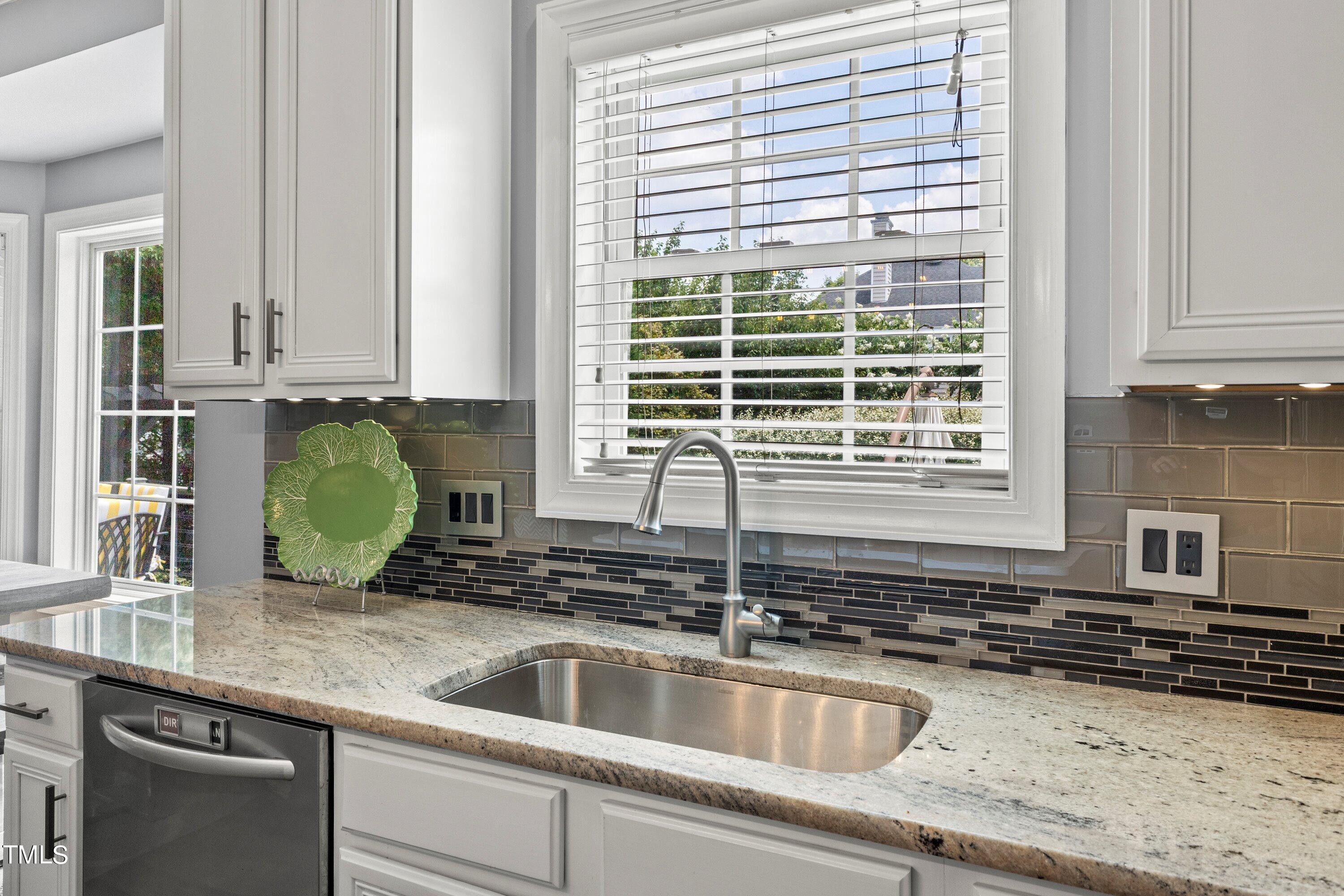 12212 Penrose Trail Raleigh, NC 27614 - Photo 20 of 41 a kitchen with granite countertop a sink and a window