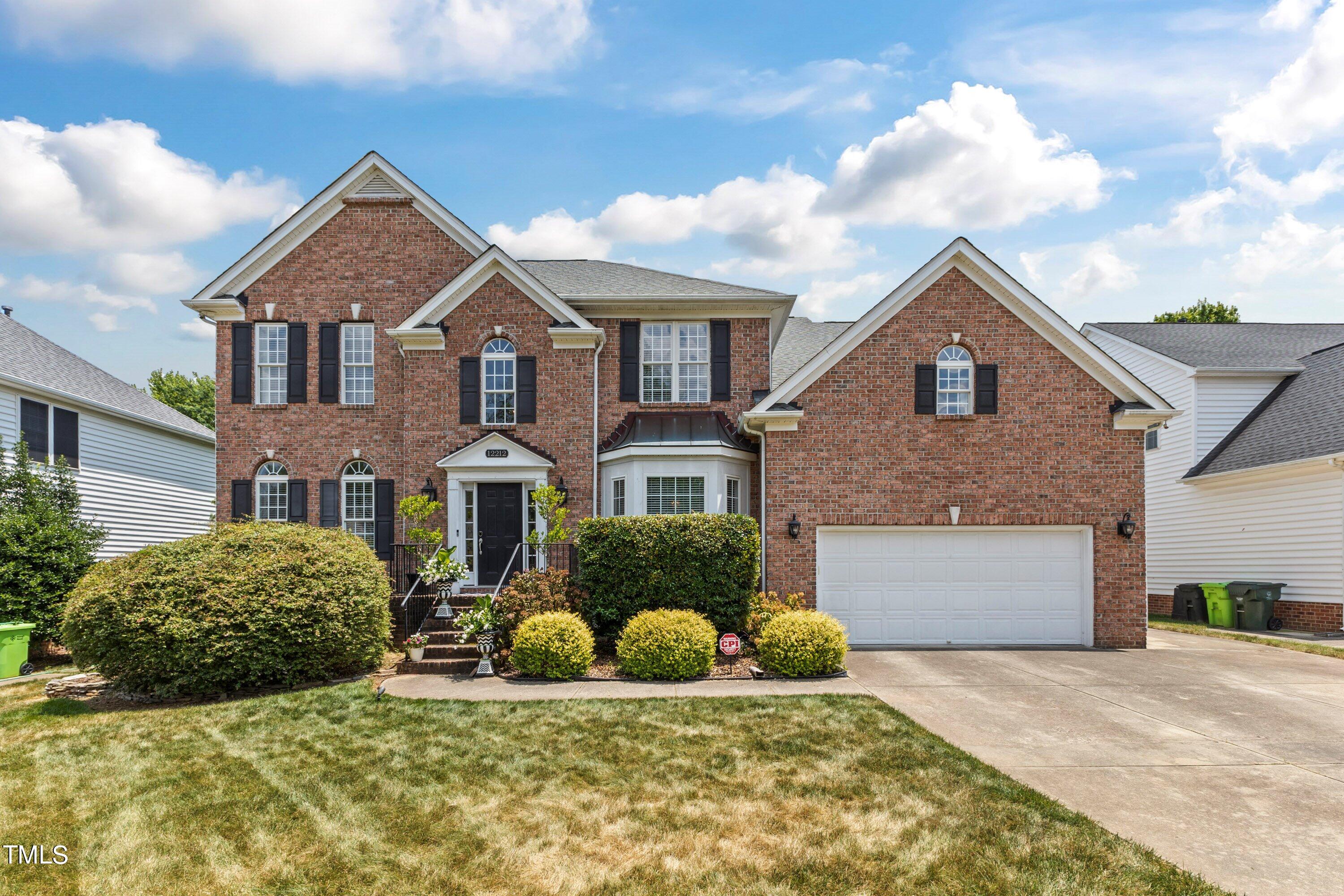 12212 Penrose Trail Raleigh, NC 27614 - Photo 2 of 41 a front view of a house with a yard and garage