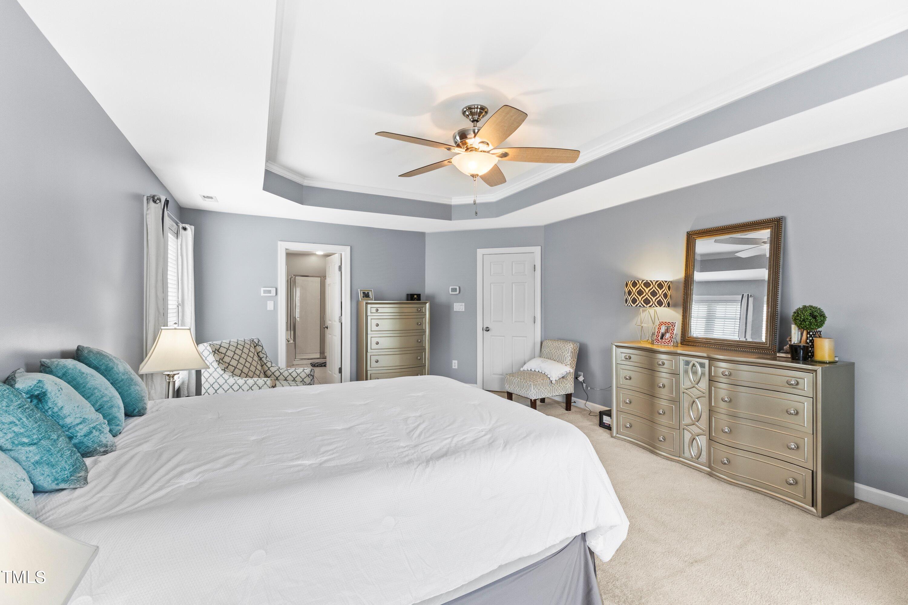 12212 Penrose Trail Raleigh, NC 27614 - Photo 24 of 41 a bedroom with a bed and a chandelier