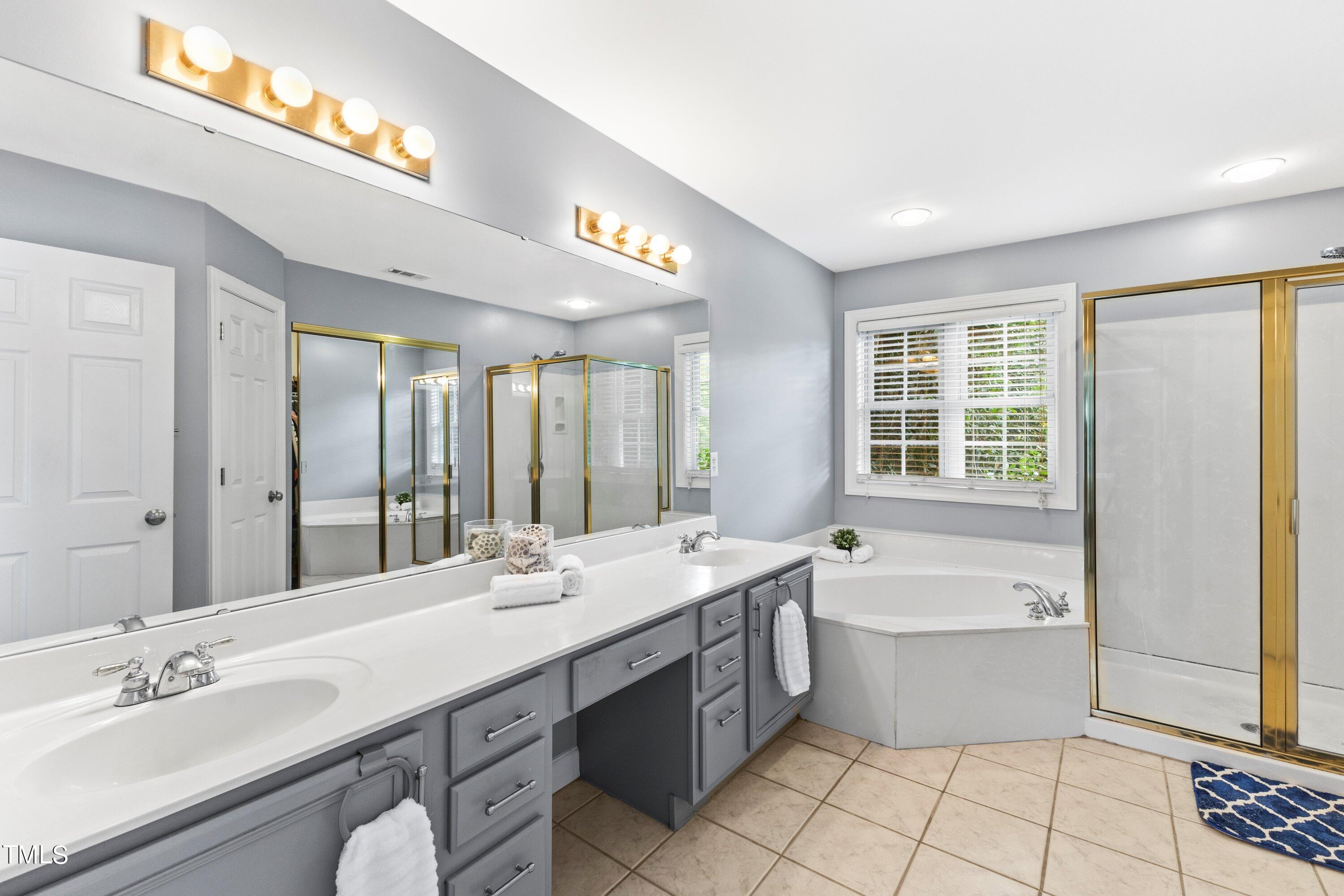 12212 Penrose Trail Raleigh, NC 27614 - Photo 25 of 41 a bathroom with a large tub sink and double vanity