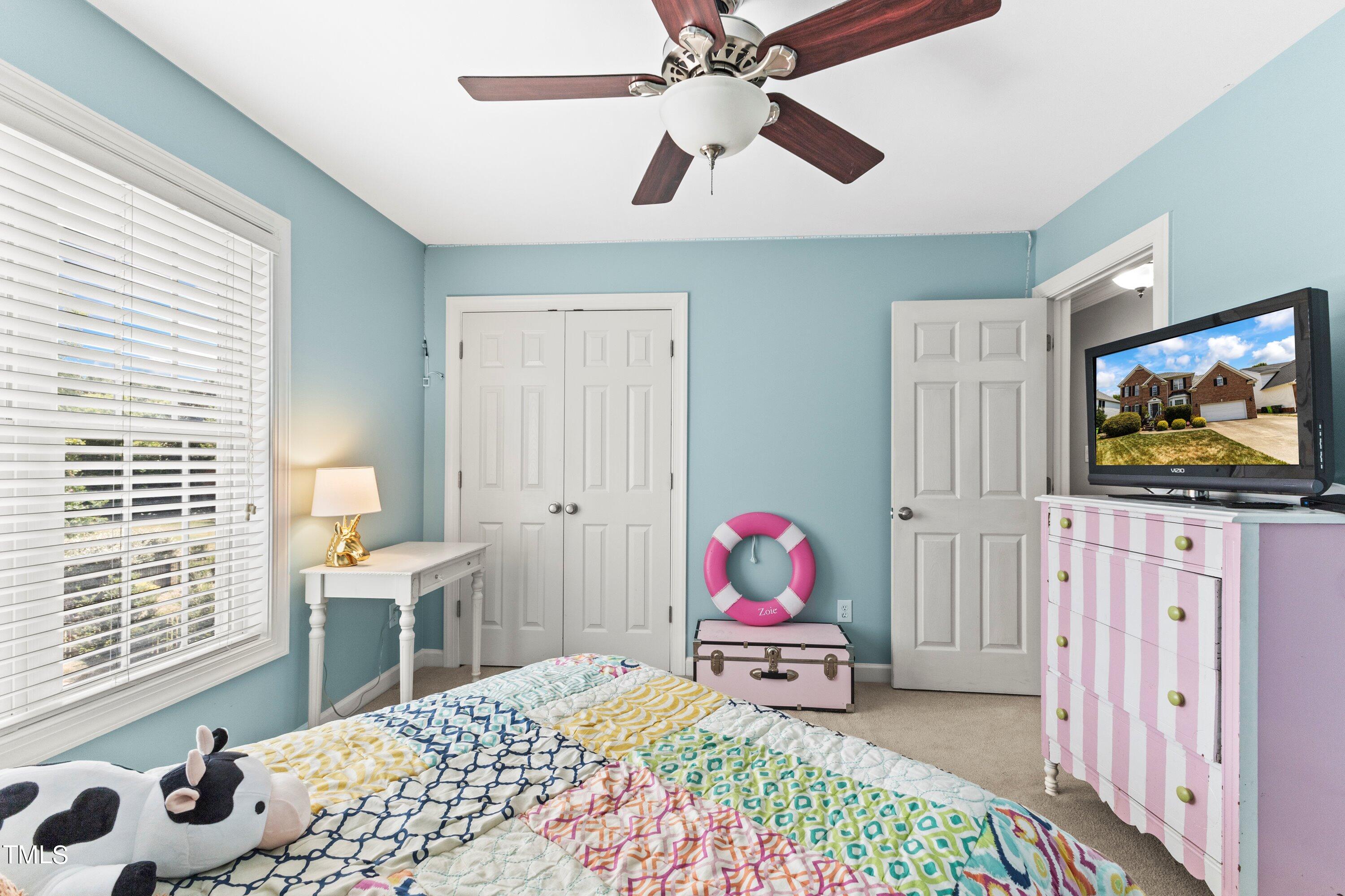 12212 Penrose Trail Raleigh, NC 27614 - Photo 28 of 41 a bedroom with a bed a window and a chandelier