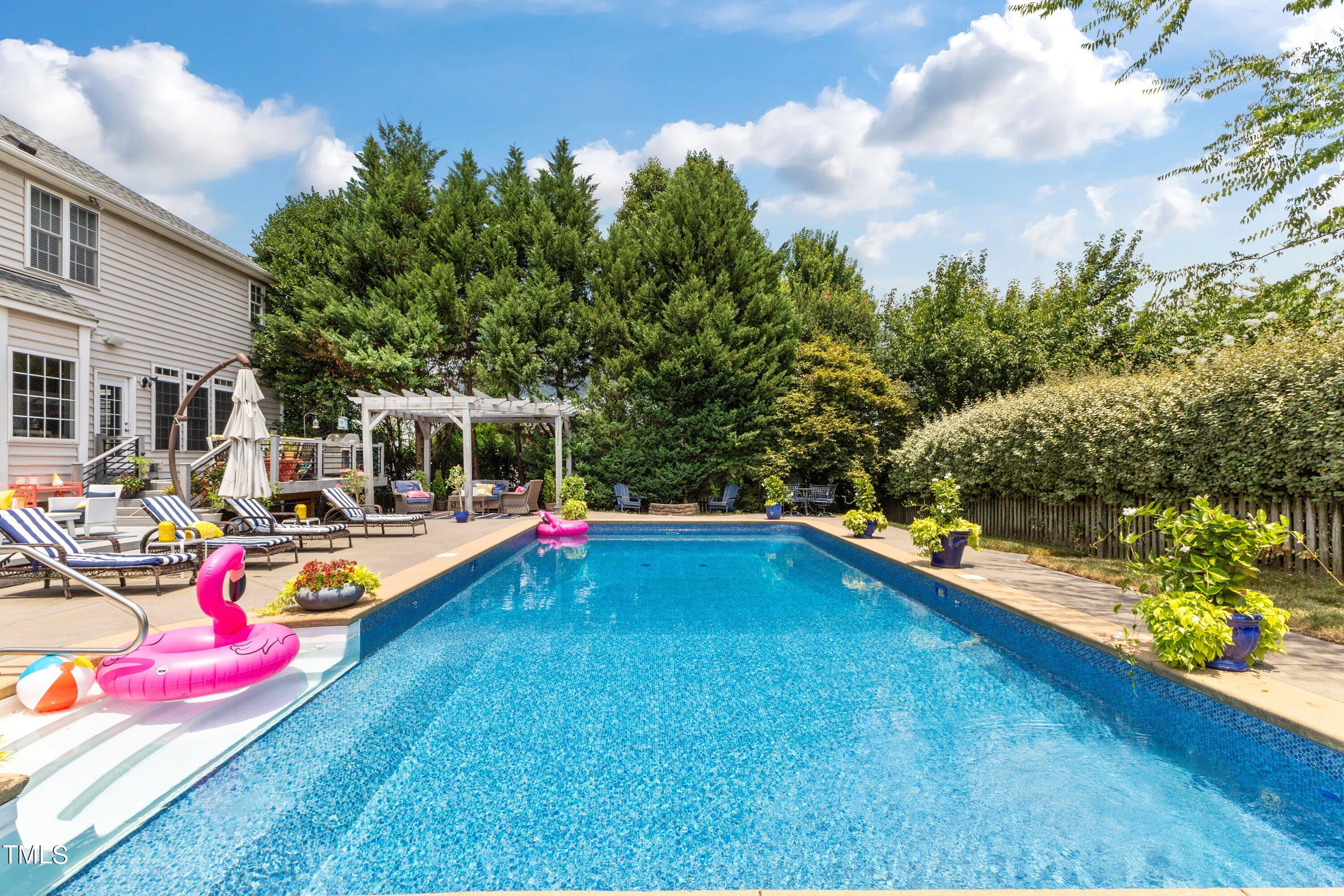 12212 Penrose Trail Raleigh, NC 27614 - Photo 36 of 41 a view of a swimming pool with a lounge chair and couches in the patio