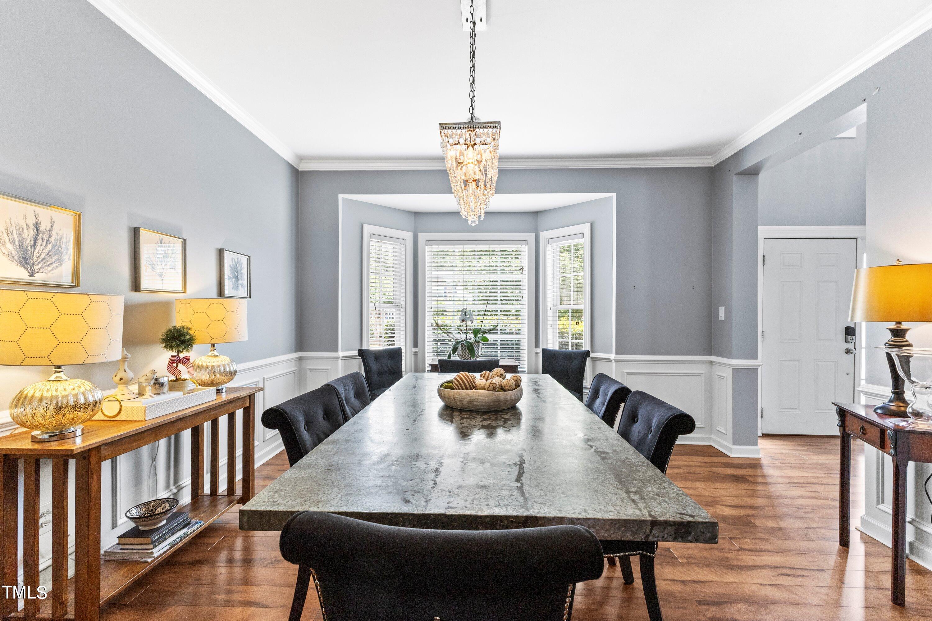 12212 Penrose Trail Raleigh, NC 27614 - Photo 9 of 41 a view of a dining room and livingroom with furniture wooden floor a chandelier
