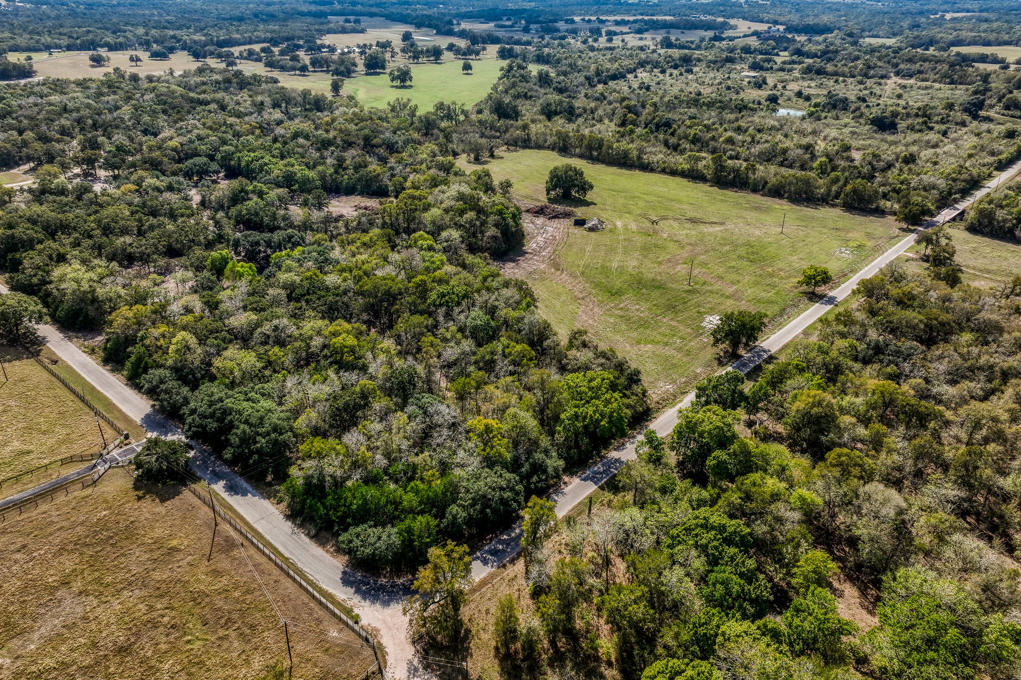 6 Sun Oil Road Brenham, TX 77833 - Photo 31 of 34 a view of a houses with a lush green forest